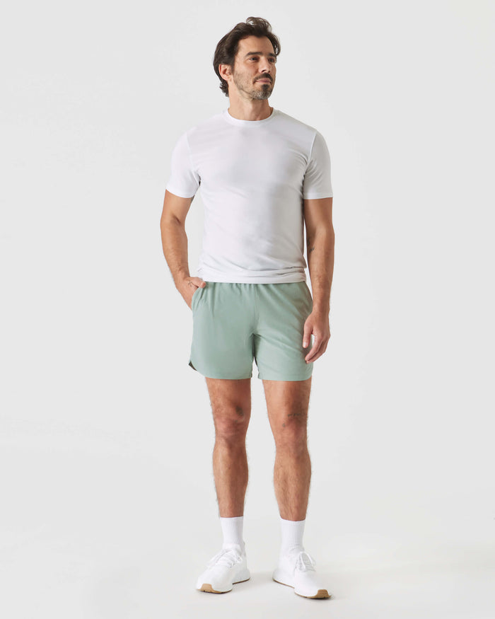 Man wearing 7 Slate Green Active Training Shorts 2.0 with white T-shirt.