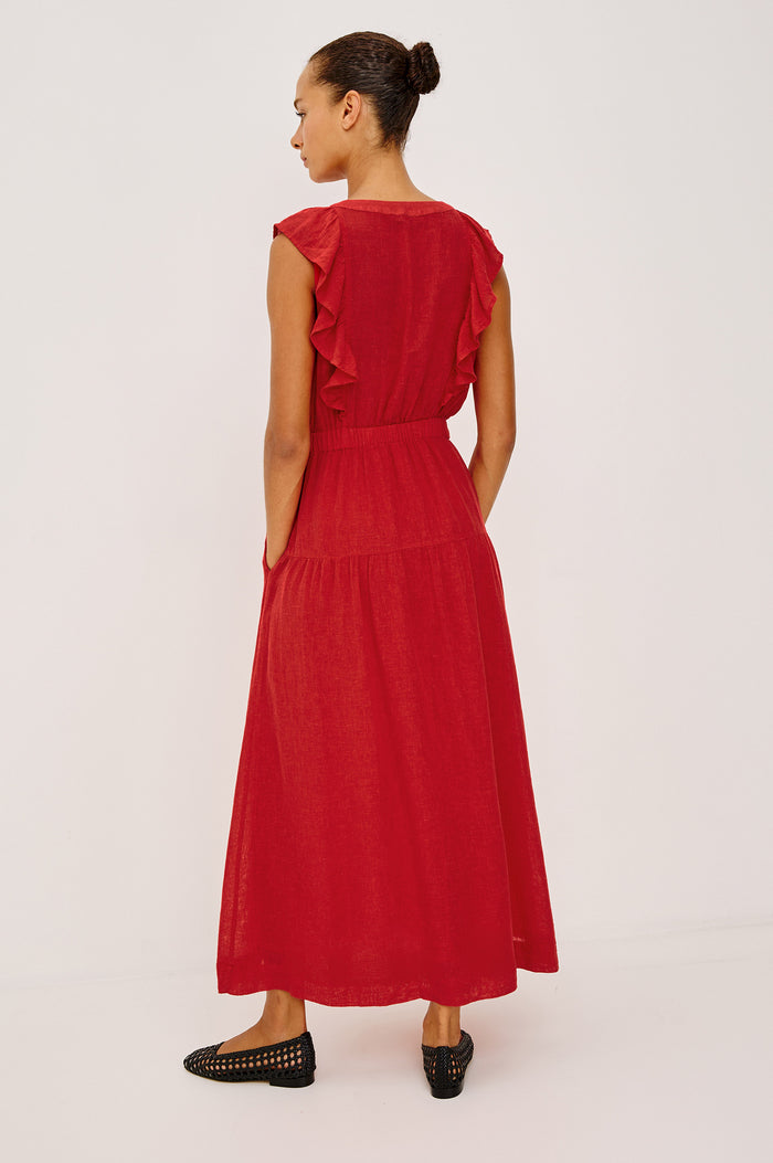 The Beaux Maxi Dress in Linen With Ruffle V-Neckline, Elastic Empire Waist, Single-Tiered Lined Skirt, and Side Pockets in Tomato Colorway - Full Body Back View Featured on Model