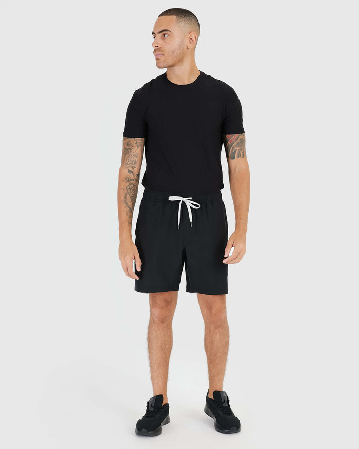 Man wearing Black Active Quick Dry Shorts with Liner and black T-shirt.
