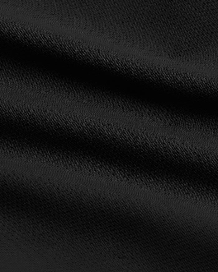Black Slim Chino Pants 2.0 with textured woven fabric folds.