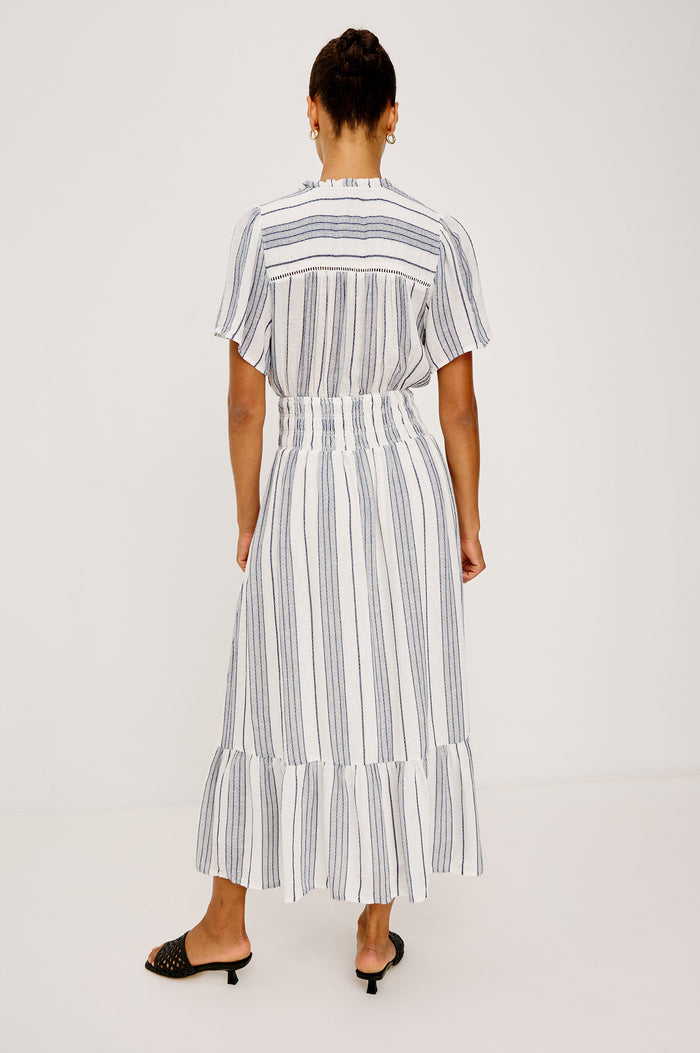 Brent Maxi Dress in Luxe Linen With Front Half Placket, Ladder and Ruffle Trim, Short Wide Sleeves, Smocked Waist, Single-Tier Hem in Salino Stripe Colorway - Full Body Back View Featured on Model