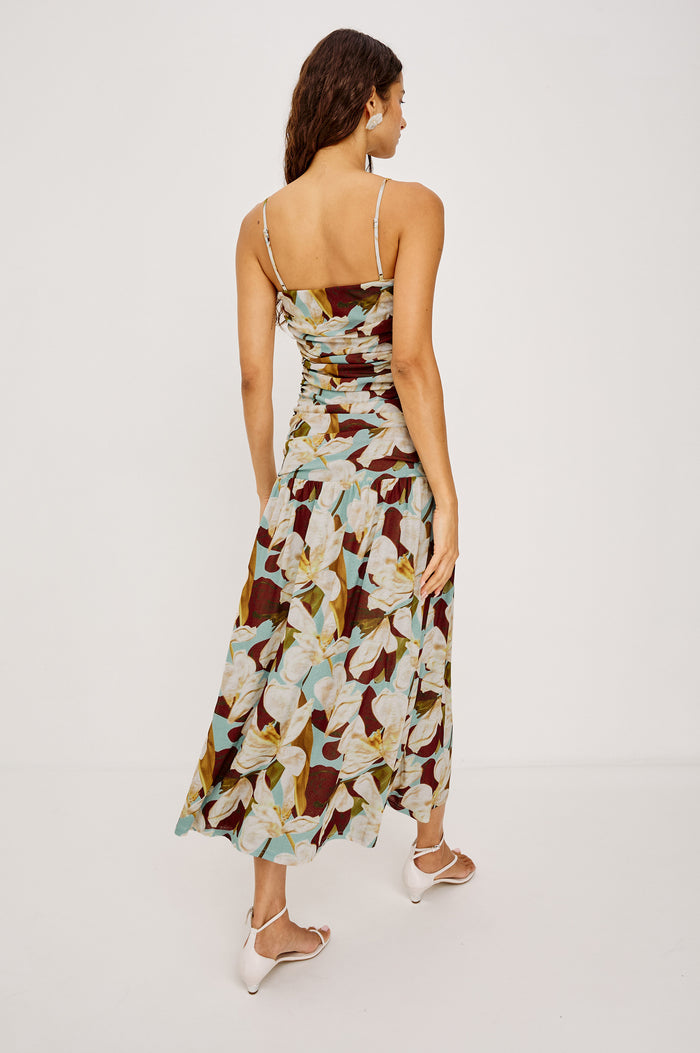 Dolly Maxi Dress in Self-Lined Mesh With Adjustable Spaghetti Straps, Straight Neckline, Ruched Body, and Full Skirt in Plumeria Colorway - Full Body Back View Featured on Model
