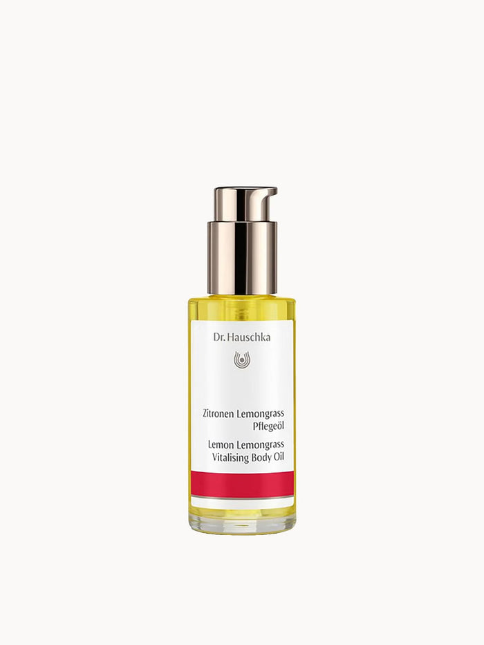 Dr. Hauschka Lemon Lemongrass Body Oil in a 75 ml bottle, featuring a clear container with yellow oil and fresh lemon and lemongrass ingredients.