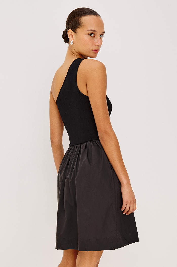 Joanne Mini Dress With One-Shoulder Neckline, Soft Jersey Bodice, Dropwaist Cotton Poplin Skirt, and Side Pockets in Black Colorway - Upper Body Back View Featured on Model