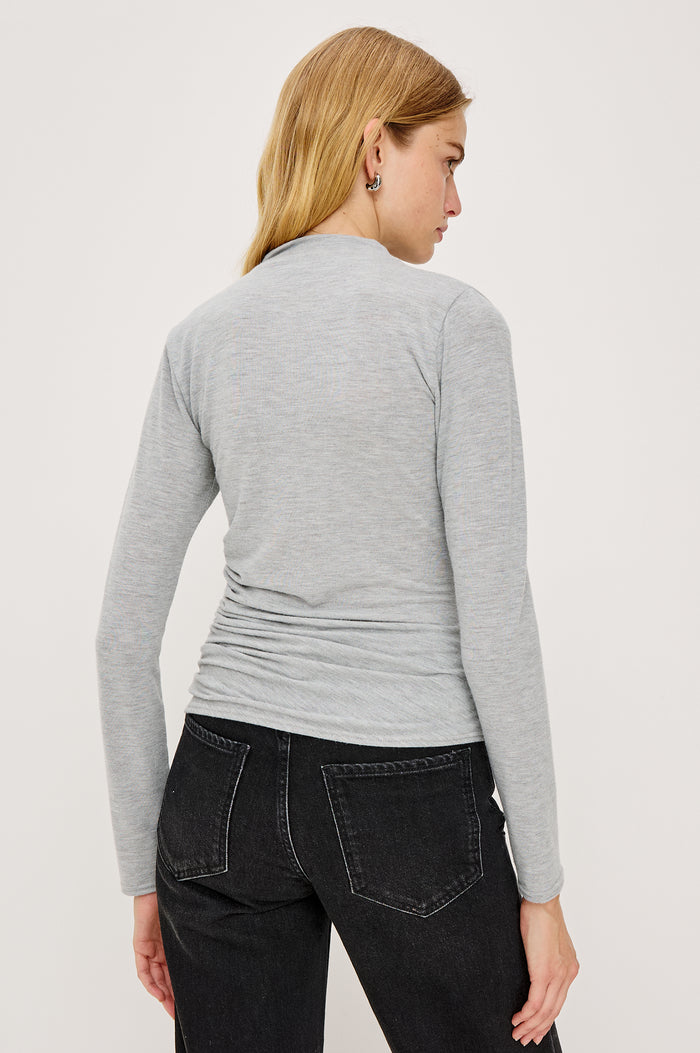 Joelle Top in Brushed Rib Jersey With Subtle Mock Neck, Fitted Silhouette, Side Shirring, and Long Sleeves in Heater Grey Colorway - Upper Body Back View Featued on Model