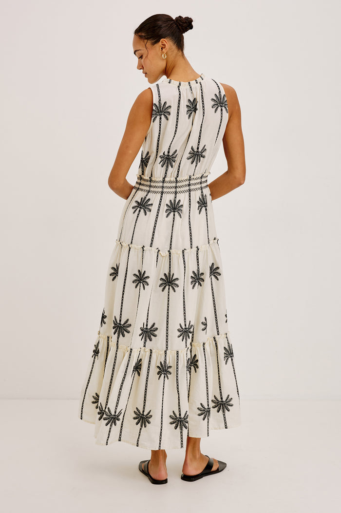 Loulou Maxi Dress in Cotton Voile With Ruffle Trim, V-Neck, Smocked Waist, and Ruffle Tier Skirt in Embroidered Palms Colorway - Full Body Back View Featured on Model