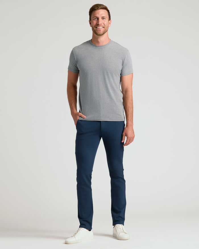 Man wearing Navy Slim Comfort Knit Chino Pant with white sneakers.