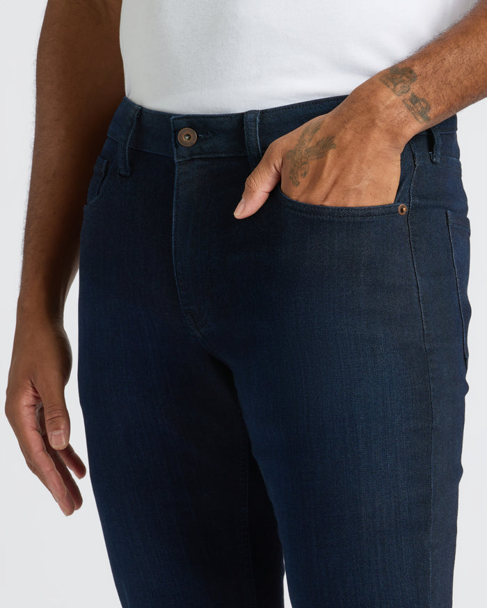 Medium Gray Wash Slim Comfort Stretch Jeans with white shirt tucked in.