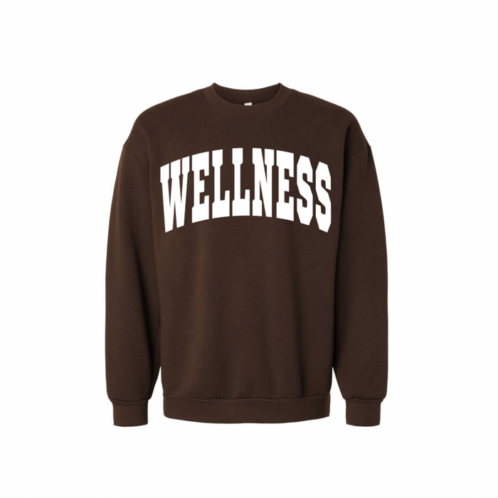 Wellness Varsity Unisex Crew Neck Sweatshirt | Lucky Owl in dark brown with bold white "WELLNESS" text across the chest, featuring a casual comfortable fit and ribbed cuffs and hem.