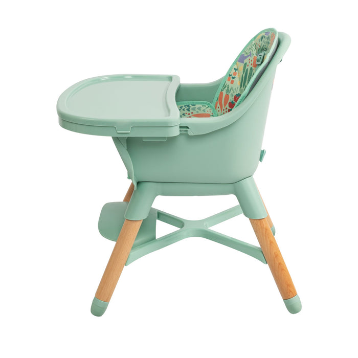The Nuby 4-in-1 Multi-Use High Chair | Green Garden features wooden legs, a detachable tray, and a colorful animal-print cushion. Its mint green design grows with your child for long-lasting use.