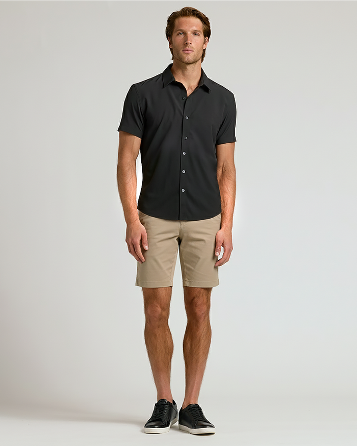 Man wearing 7 Black & Khaki Chino Shorts 2-Pack with black sneakers.