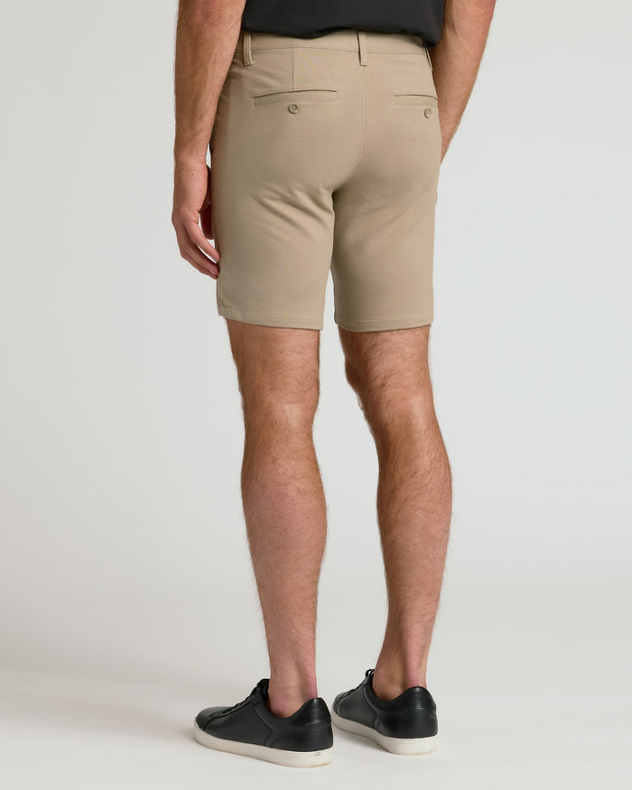 7 Khaki Chino Shorts 2.0, back view, worn with black sneakers.