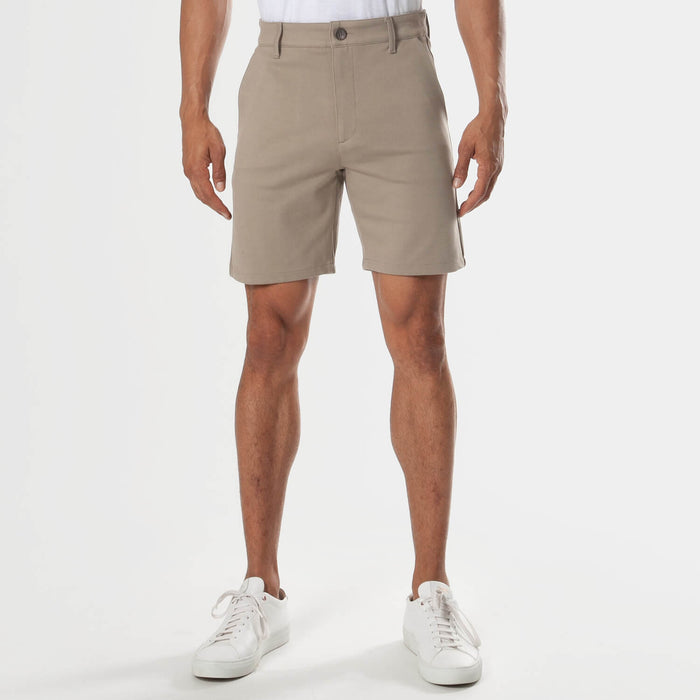 7 Khaki Comfort Knit Chino Shorts worn with white sneakers.