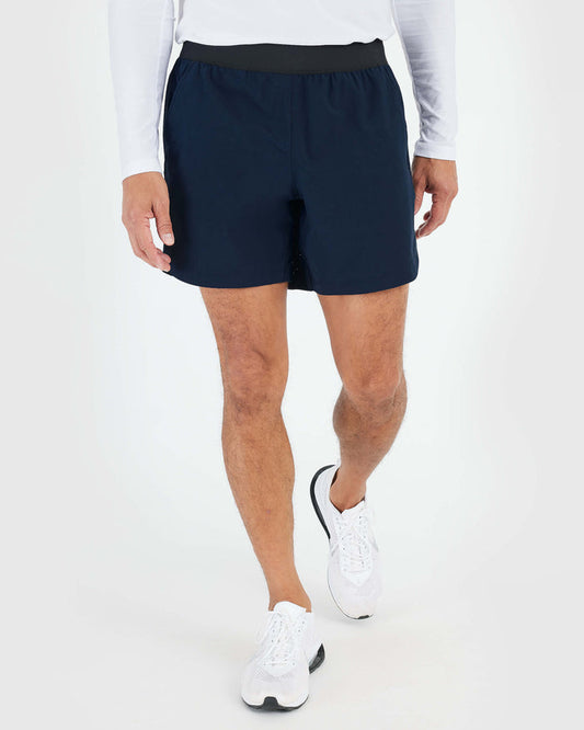 7 Navy Active Training Short on person walking, showcasing athletic fit.