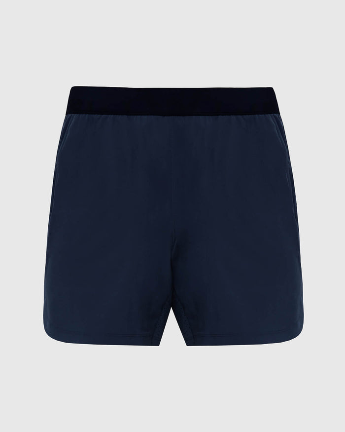 7 Navy Active Training Short with dark waistband and front hem split.