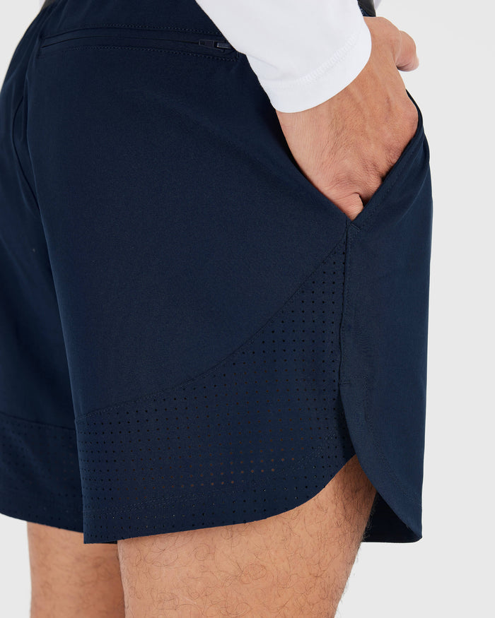 7 Navy Active Training Short with side pocket, ventilation panels, and zippered back pocket.