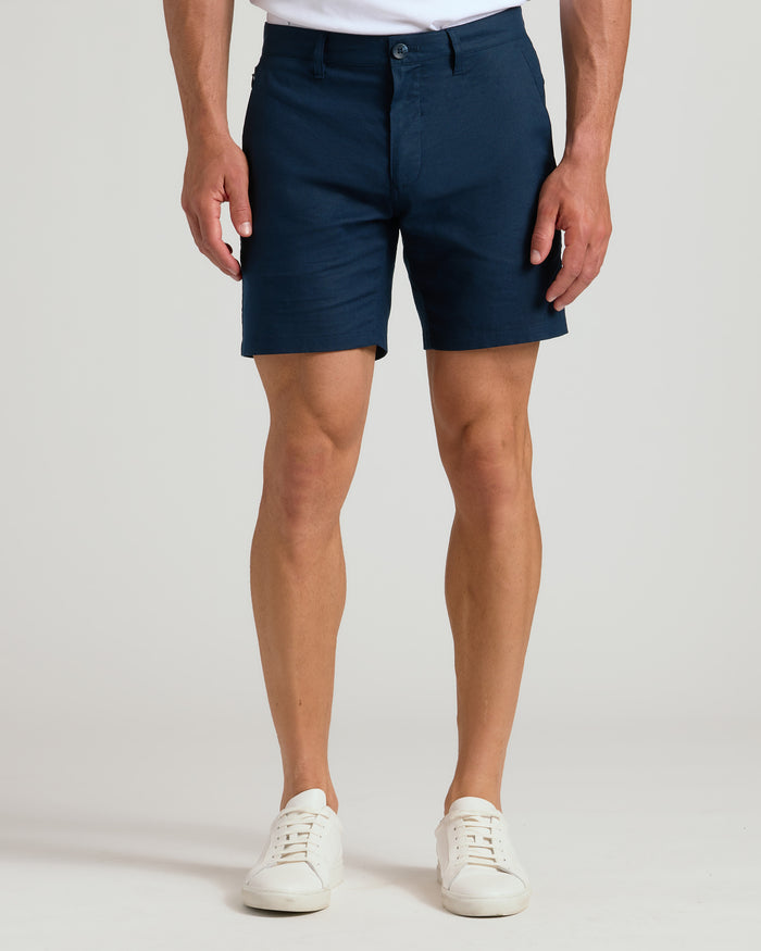 7 Navy Linen Shorts with white sneakers against a neutral background.