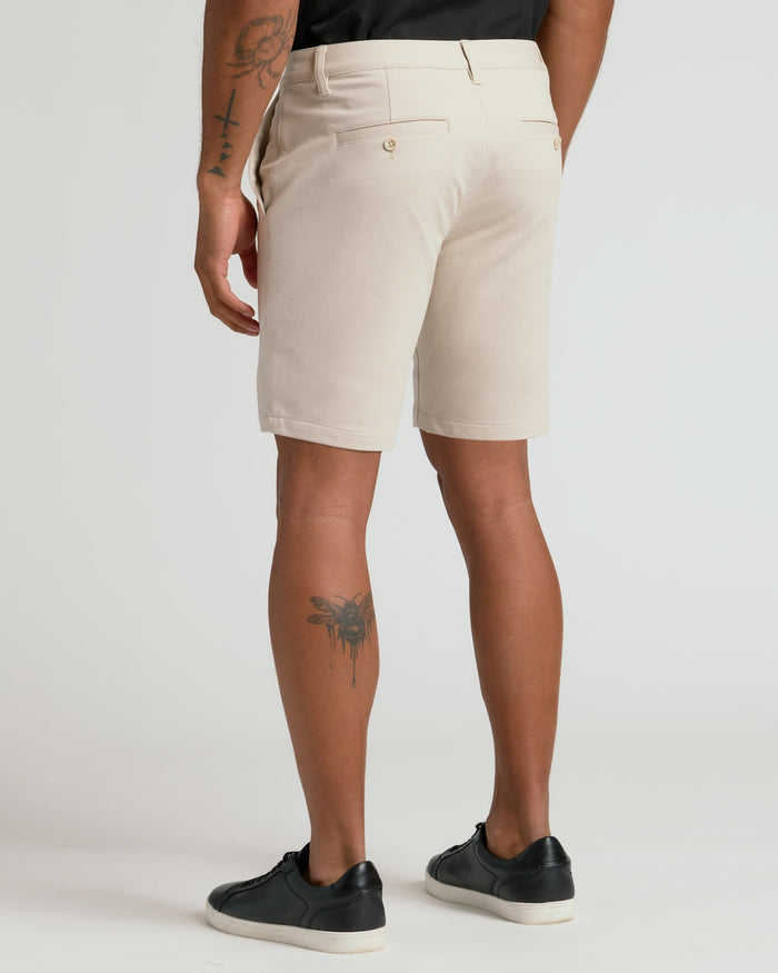 7 Sandstone Chino Shorts 2.0 paired with black sneakers.