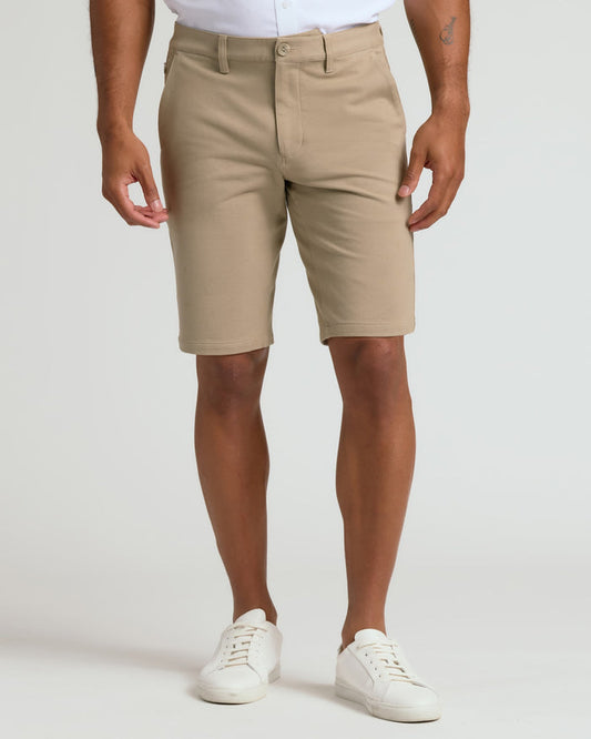 Man wearing 9 Black & Khaki Chino Shorts 2-Pack with white sneakers.