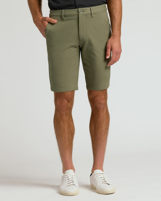 Man wearing 9 Military Green Chino Shorts 2.0 and white sneakers.