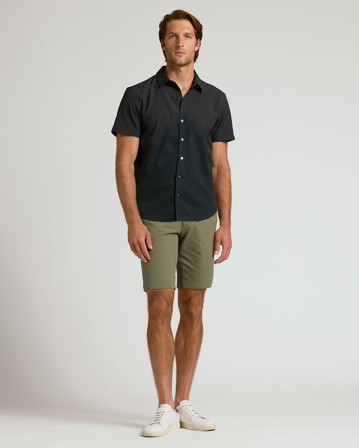 Man wearing 9 Military Green Chino Shorts 2.0 with black shirt and sneakers.
