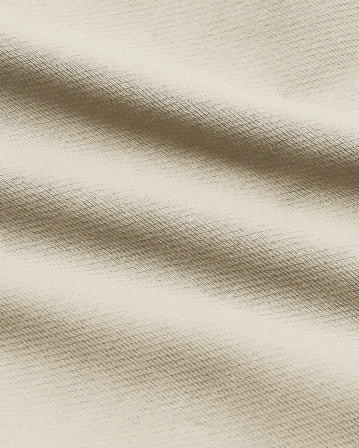 9 Sandstone Chino Shorts 2.0, light-beige woven texture, gentle fabric folds.
