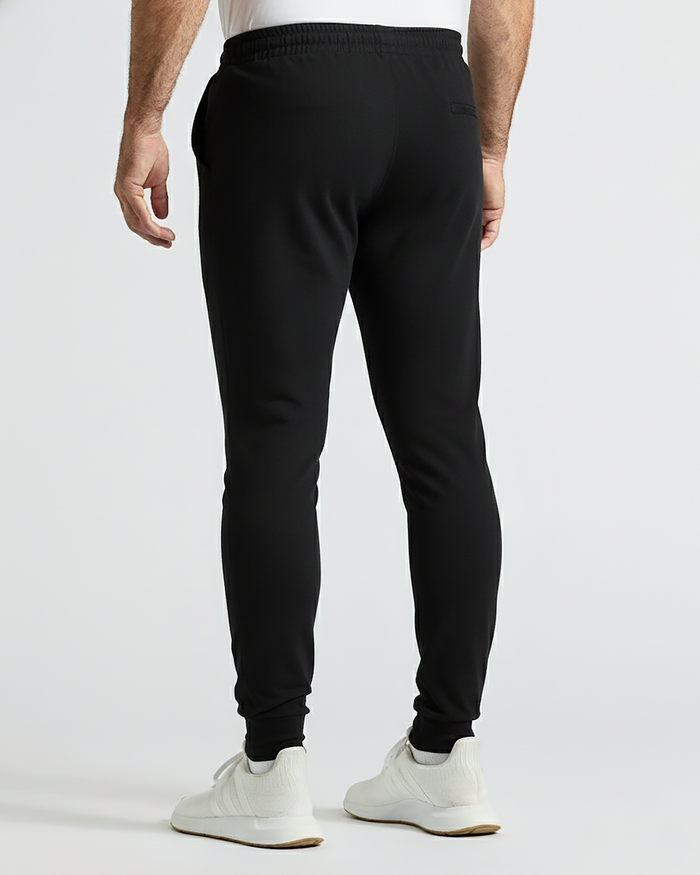 Man wearing Black Active Joggers with elastic waistband and back pocket.