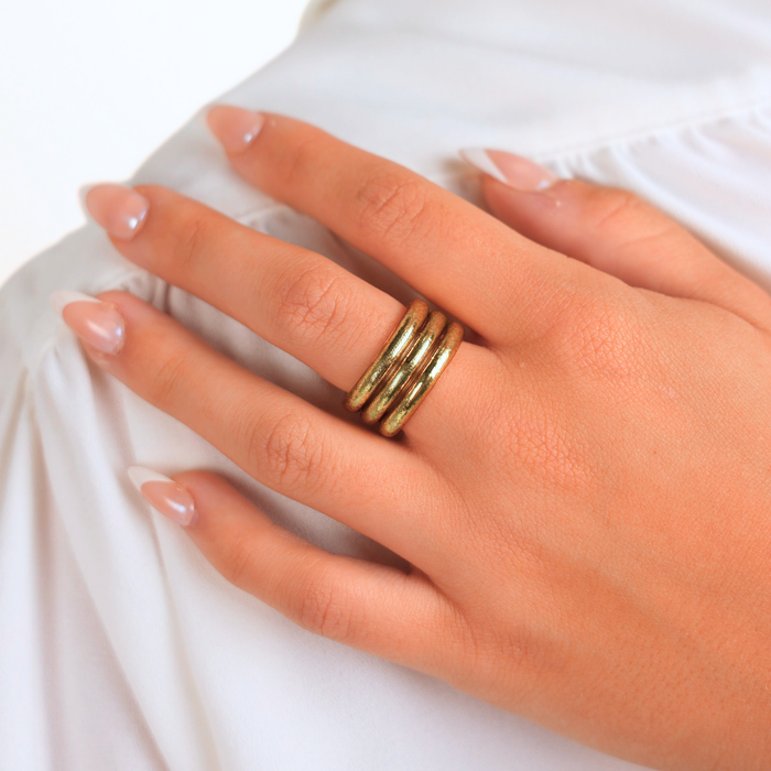 Aura All Weather Rings (Set of 3) beautifully displayed on a hand with luminous Aura Gold finish, ideal for everyday wear.