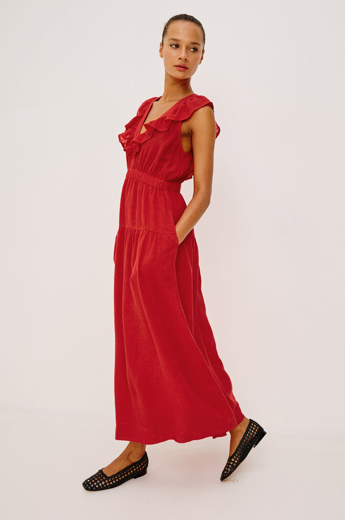 Beaux Maxi Dress in Linen With Ruffle V-Neckline, Elastic Empire Waist, Single-Tiered Lined Skirt, and Side Pockets in Tomato Colorway - Full Body Front View Featured on Model