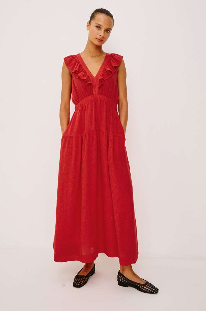 The Beaux Maxi Dress in Linen With Ruffle V-Neckline, Elastic Empire Waist, Single-Tiered Lined Skirt, and Side Pockets in Tomato Colorway - Full Body Front View Featured on Model