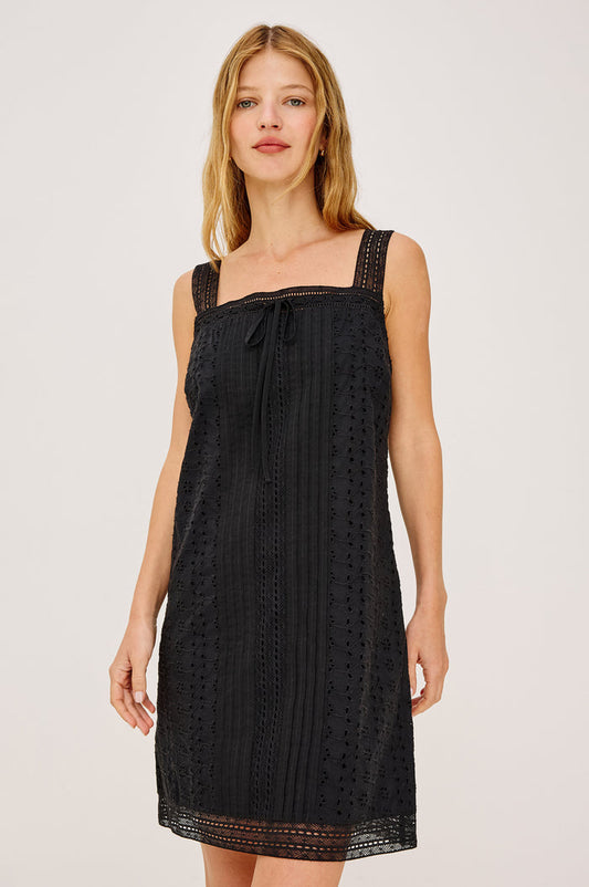 Beckton Mini Shirt Dress With Square Neckline, Eyelet Embroidery, Front Pintucks, Center-Front Ties, and Lace Shoulder Straps in Black Colorway - Upper Body Front View Featured on Model