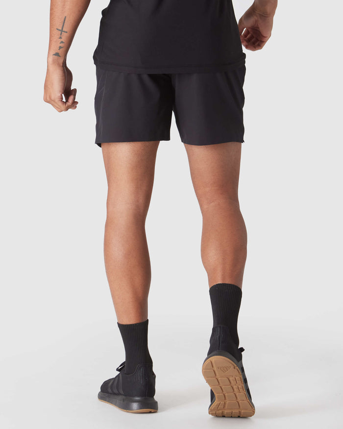 Black 2 In 1 Training Short with gum outsole Adidas sneakers.