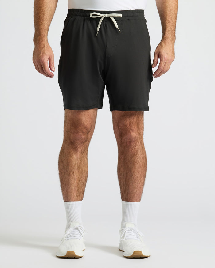 Black Active Comfort Shorts with drawstring and pockets, worn with athletic socks and shoes.