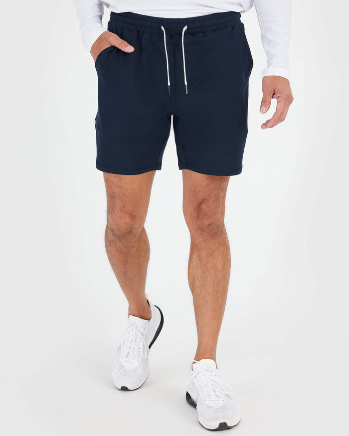 Model wearing Black & Dark Heather Navy Active Comfort Shorts mid-step.