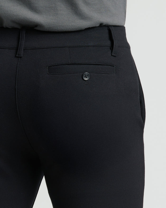 Black Slim Comfort Knit Chino Pant with back button-closure pocket and belt loops.