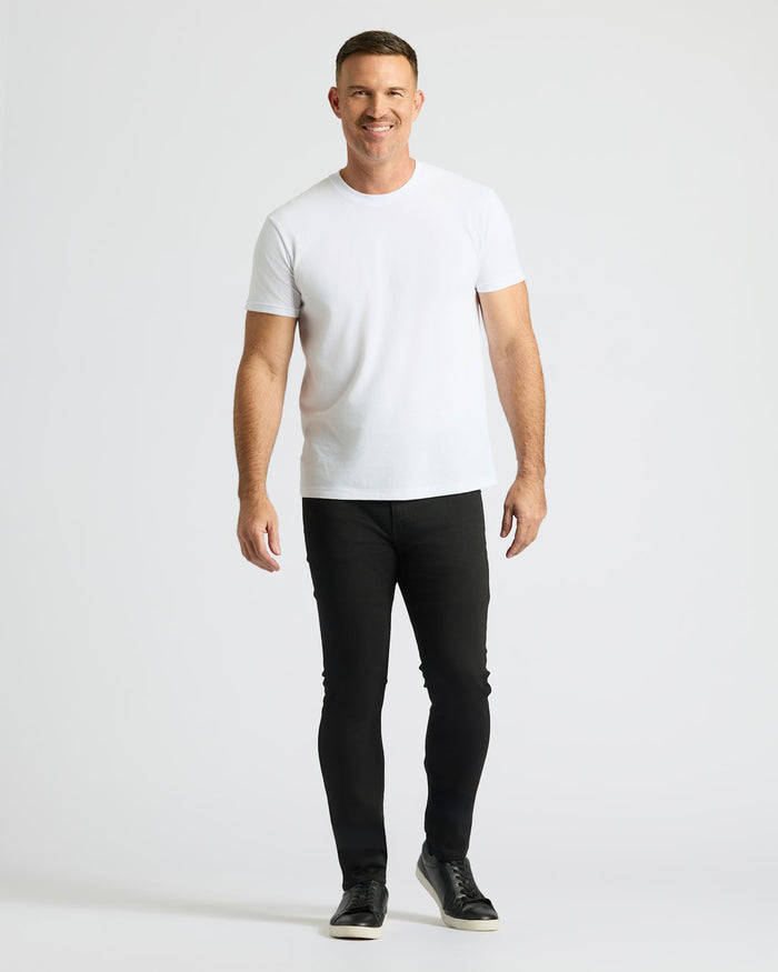 Man wearing Black Wash Slim Comfort Stretch Jeans with a white t-shirt.
