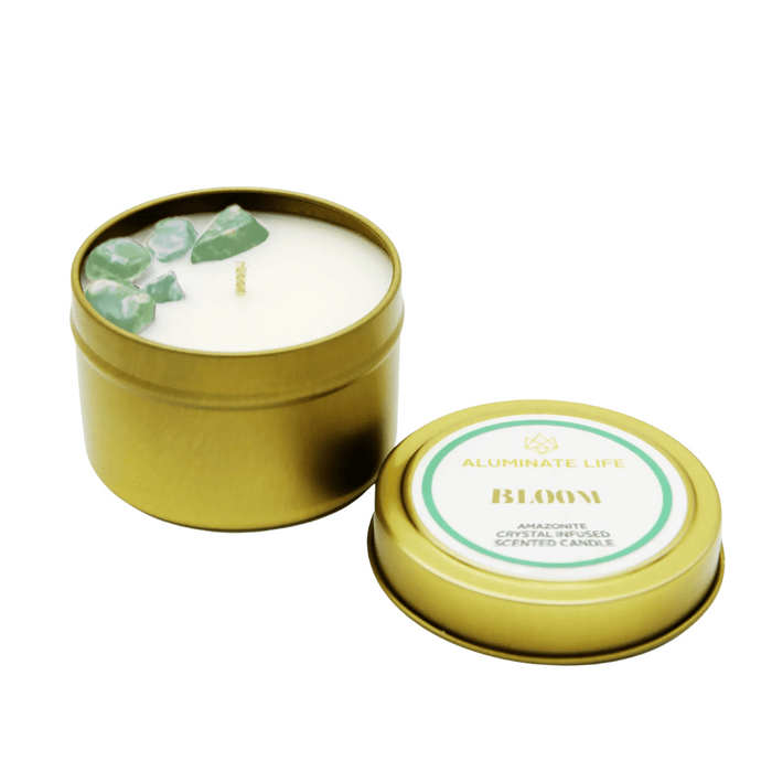 Bloom Candle Tin | Aluminate Life featuring a gold tin container with a white candle infused with green amazonite crystals, designed for skincare and wellness ambiance.