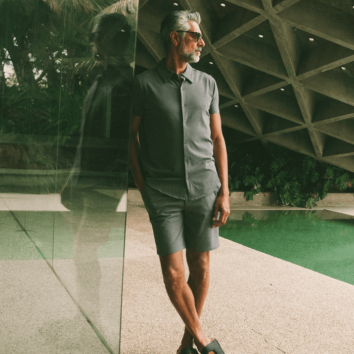 Man in Carbon 7.5 Inseam Chino Shorts by pool.