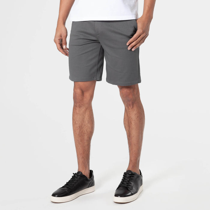 Carbon Comfort Chino Short with black sneakers on a person.