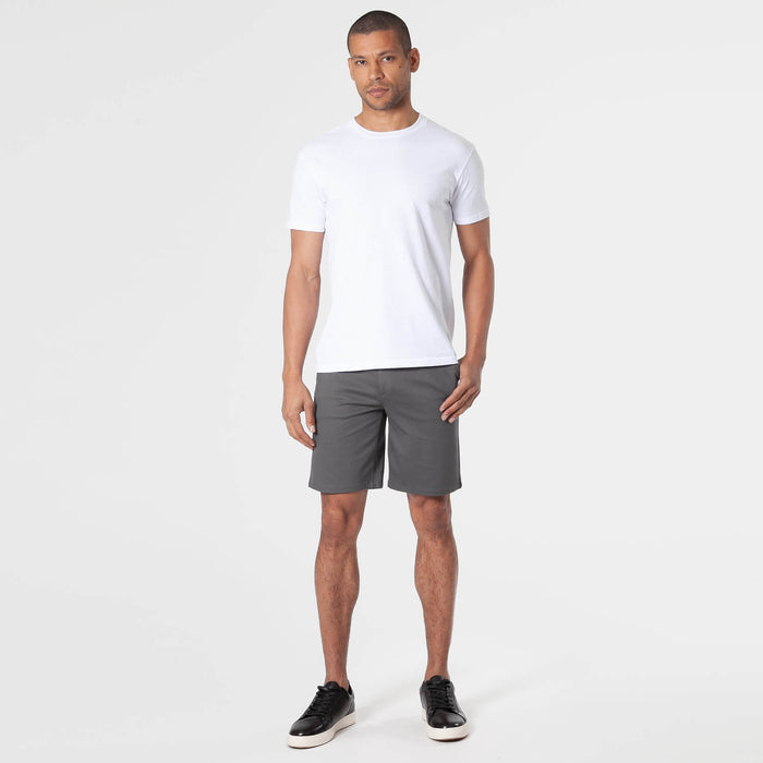 Man wearing Carbon Comfort Chino Short, white T-shirt, black sneakers.