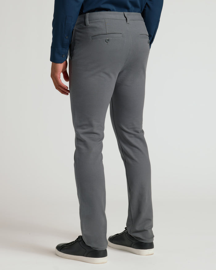 Person wearing Carbon Slim Chino Pants 2.0 with black sneakers.
