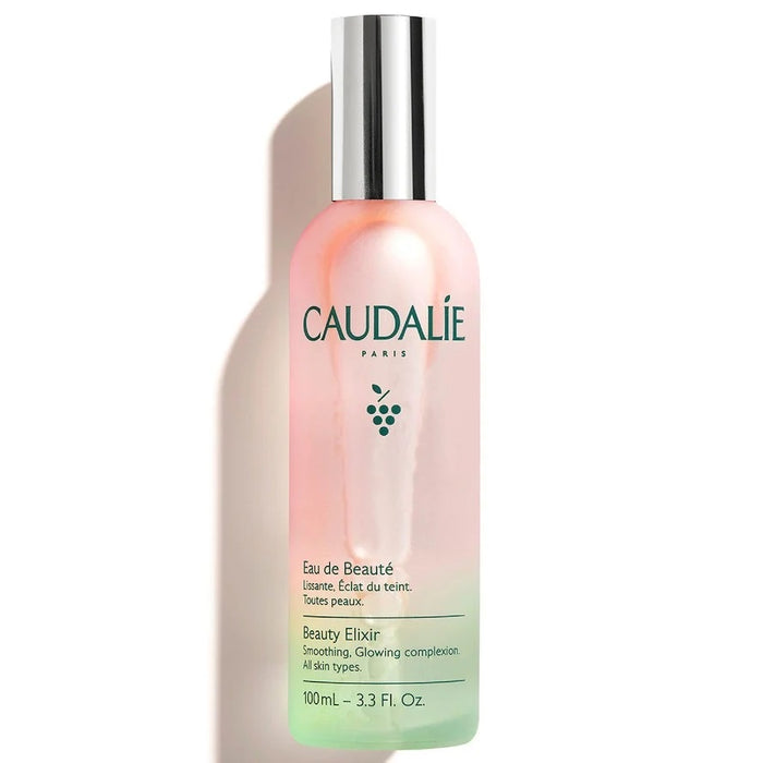 Caudalie Beauty Elixir 100ml skin care spray bottle with a gold cap and label, designed to refresh and hydrate the skin.