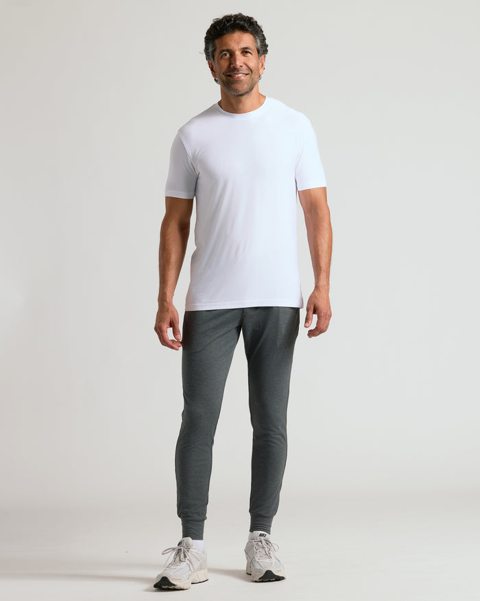 Man wearing Charcoal Heather Gray Active Joggers, white T-shirt, and Nike shoes.