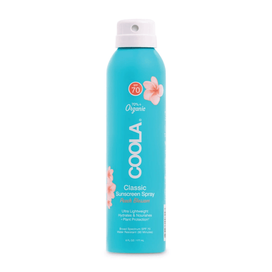 Classic Body Organic Sunscreen Spray SPF 70 | COOLA in a turquoise spray bottle with peach blossom design, offering lightweight, hydrating, broad-spectrum sun protection.