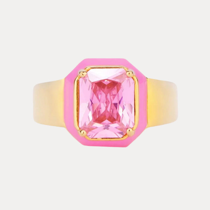 a pink and gold ring with a pink stone