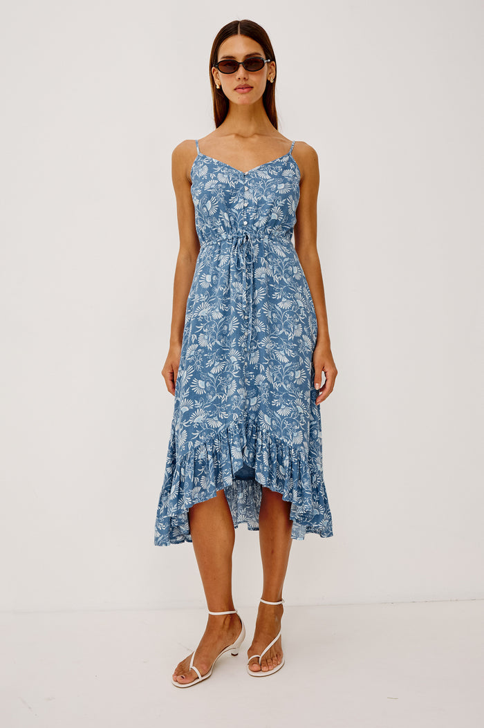 Frida Midi Dress in Luxe Linen With Center-Front Buttons, Adjustable Waist Ties, Adjustable Spaghetti Straps, High-Low Hem, and Full Cotton Lining in Blue Cassia Colorway - Full Body Front View Featured on Model