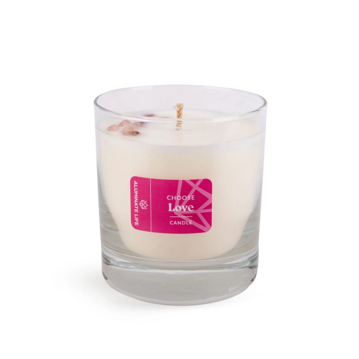 Clear glass candle with a white wax and pink label reading "Choose Love" containing small crystal accents, representing the I Choose Bliss Candle | Aluminate Life for wellness and relaxation.