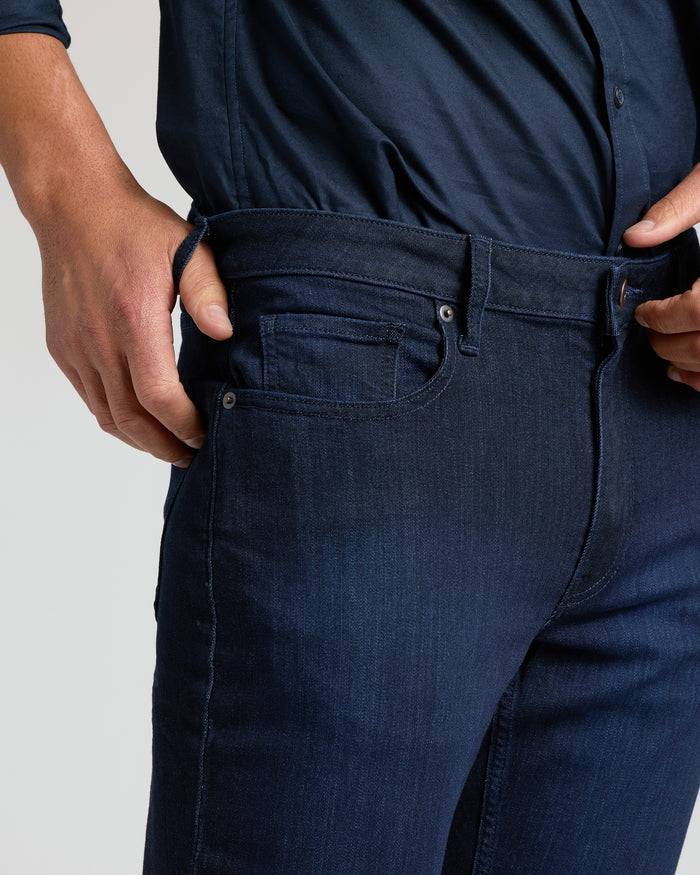 Indigo Wash Straight Comfort Stretch Jeans being worn and adjusted at waistband.
