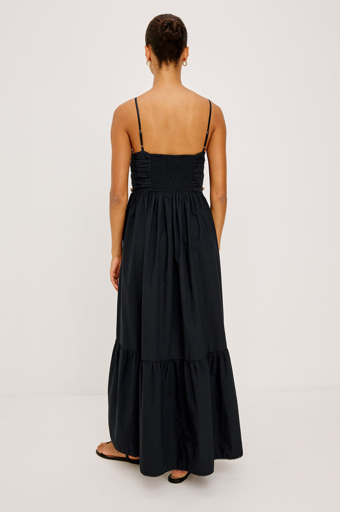 Ivana Maxi Dress in Cotton Poplin With Adjustable Spaghetti Straps, Ruched Bodice With Braided Trim and Beaded Embellishments, and Full Skirt in Black Colorway - Full Body Back View Featured on Model