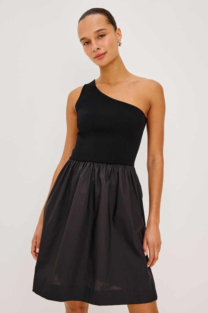 Joanne Mini Dress With One-Shoulder Neckline, Soft Jersey Bodice, Dropwaist Cotton Poplin Skirt, and Side Pockets in Black Colorway - Upper Body Front View Featured on Model